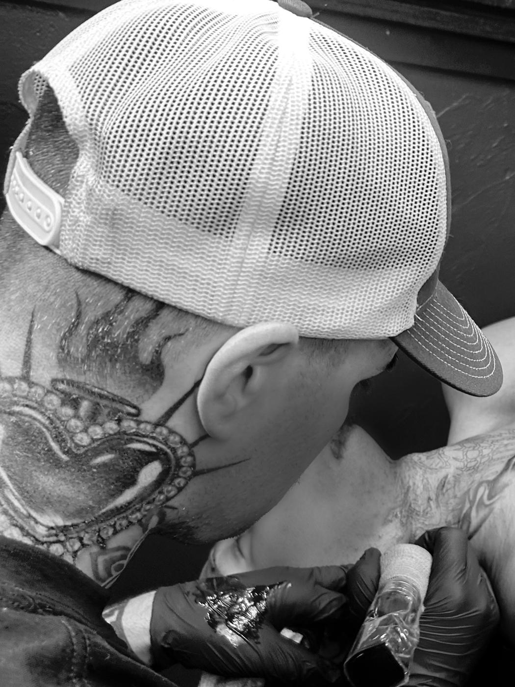 Patrick Shaw at work, tattooing a client's shoulder